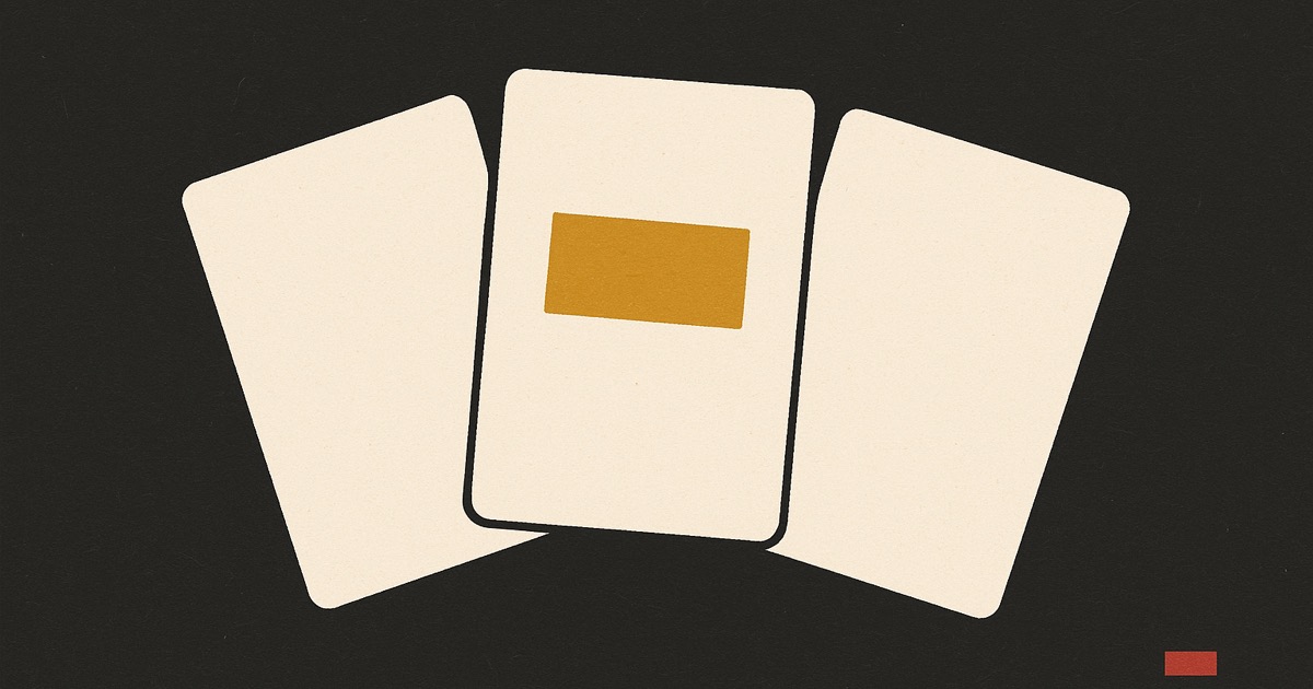 Three ivory cards fanned across charcoal, the middle one carrying an ochre block